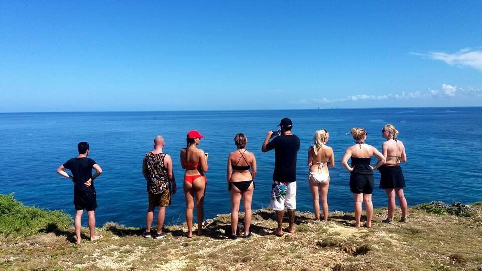 Group standing on a clifftop looking out over the open sea
