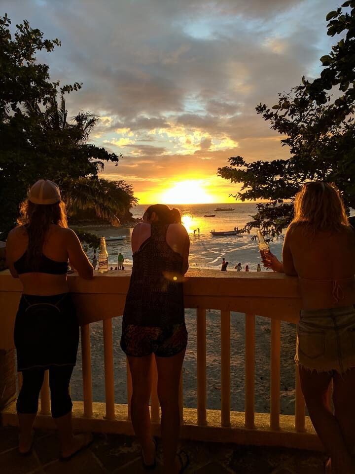 Guests watching the sunset from a beachfront deck at Malapascua