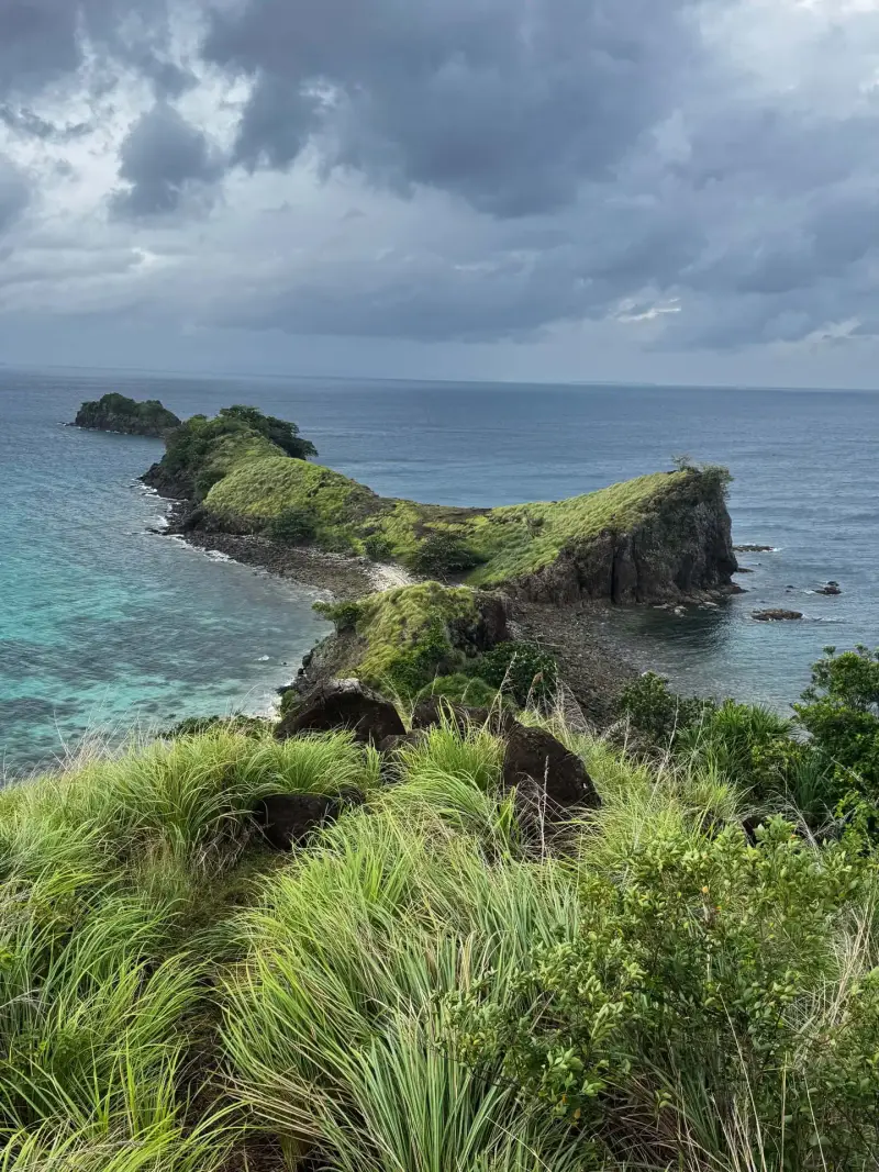 Grassy ridge on Sambawan Island looking out over rocky islets and open sea, Biliran